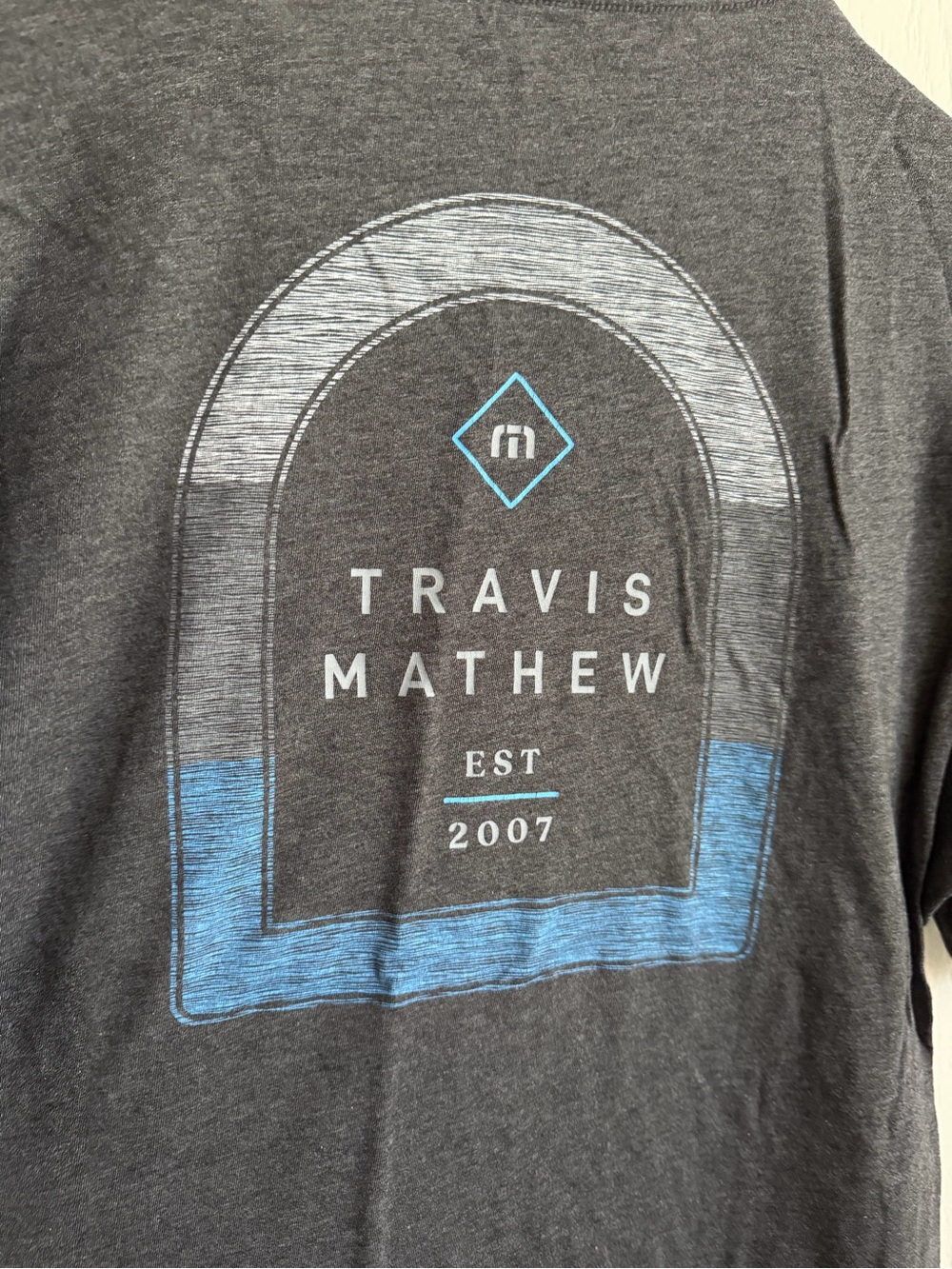 Travis Mathew Charcoal Graphic Tee with Blue Accent